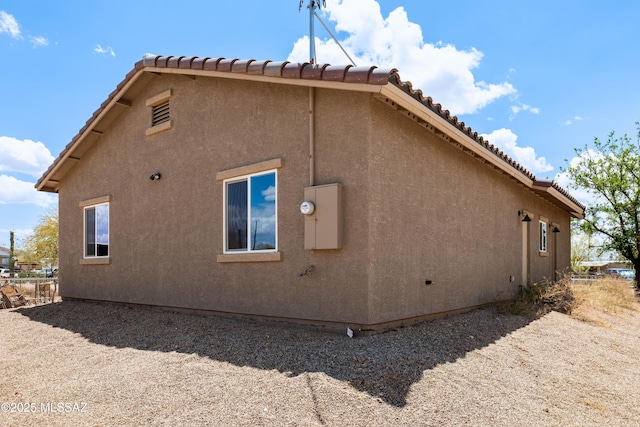6860 W Walking M, Tucson, AZ 85757 - view of side of home featuring stucco siding and a tiled roof