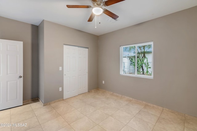 6860 W Walking M, Tucson, AZ 85757 - unfurnished bedroom featuring light tile patterned floors, ceiling fan, a closet, and visible vents