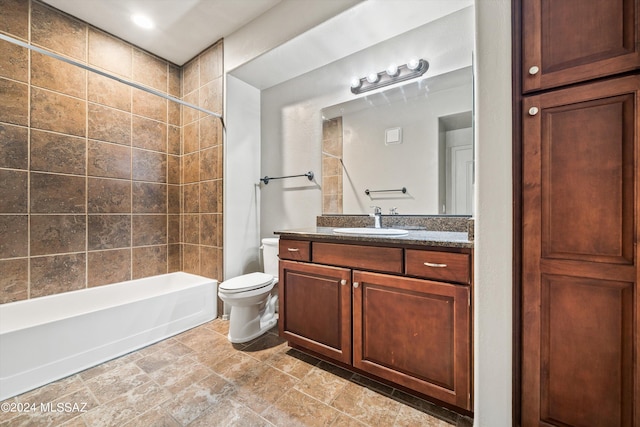 full bathroom featuring vanity, toilet, and tiled shower / bath