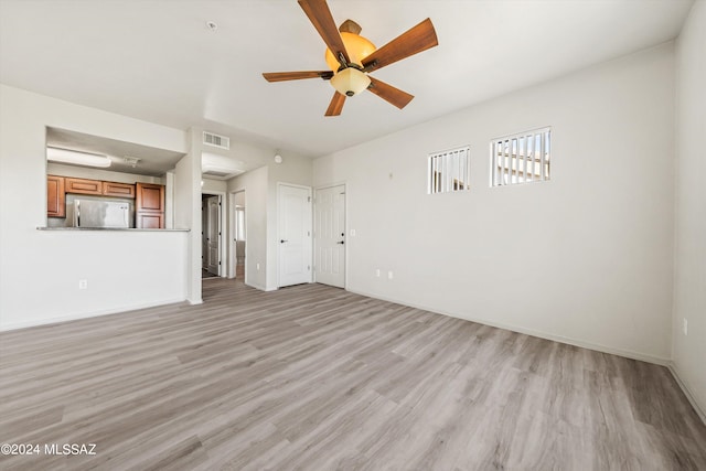 unfurnished living room featuring light wood-type flooring and ceiling fan