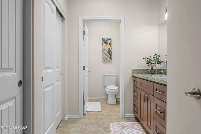 bathroom with tile patterned floors, vanity, and toilet