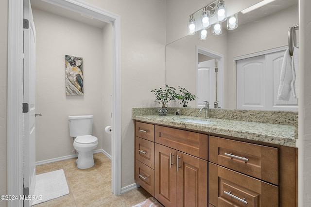 bathroom featuring tile patterned floors, vanity, and toilet