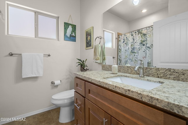 bathroom featuring tile patterned flooring, a shower with curtain, vanity, and toilet