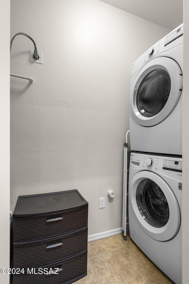 laundry room featuring stacked washer and clothes dryer