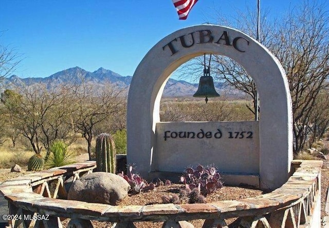 community sign with a mountain view