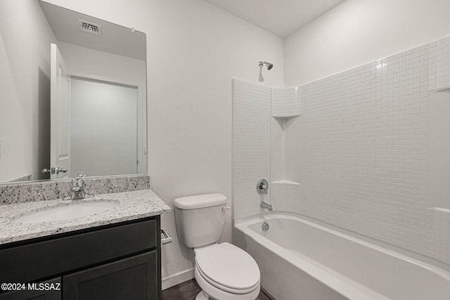 full bathroom featuring toilet, washtub / shower combination, and vanity