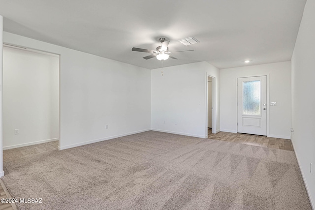 carpeted empty room featuring ceiling fan