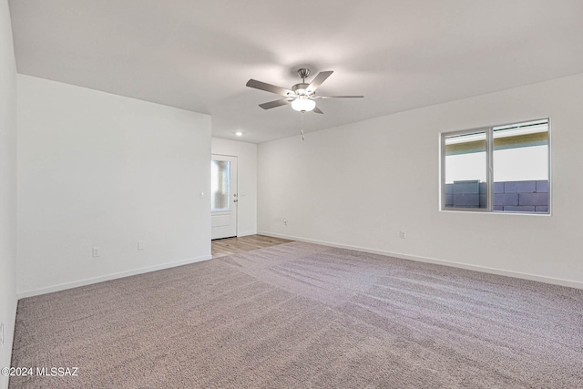 unfurnished room featuring ceiling fan and light colored carpet