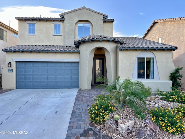 mediterranean / spanish-style house featuring a garage