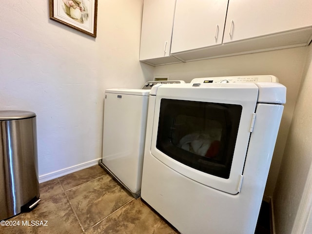 laundry room with cabinets and washer and clothes dryer