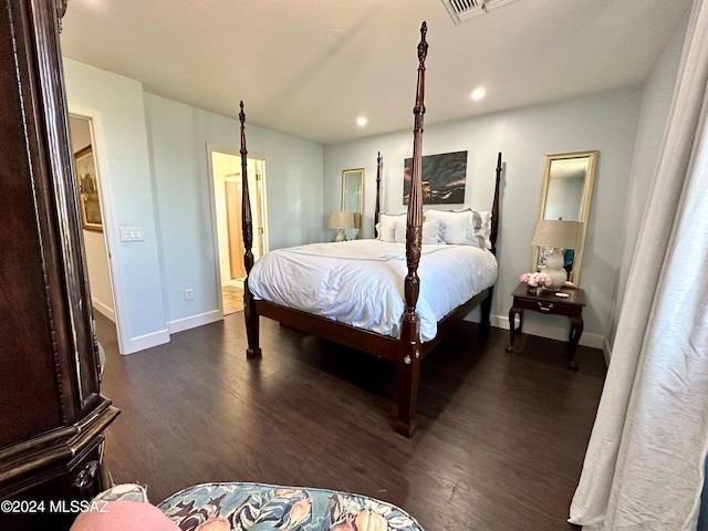 bedroom with dark hardwood / wood-style flooring