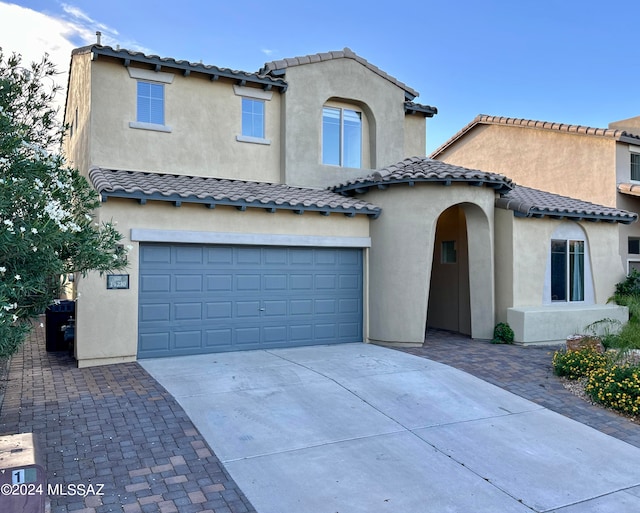 mediterranean / spanish-style home featuring a garage