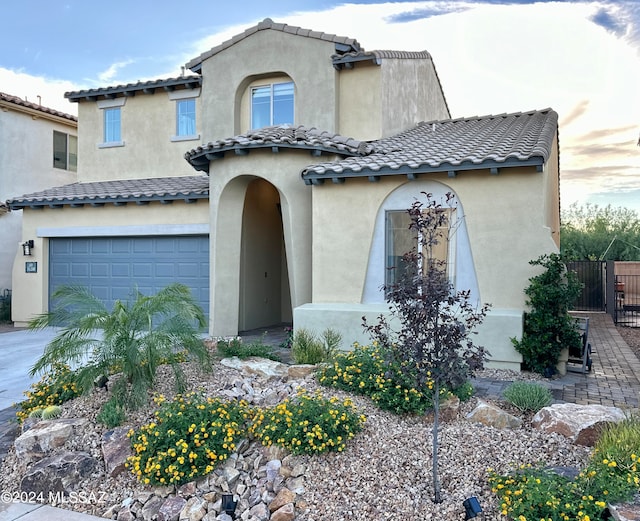 mediterranean / spanish-style home with a garage