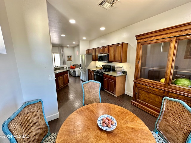 kitchen with dark wood-type flooring, stainless steel appliances, and sink