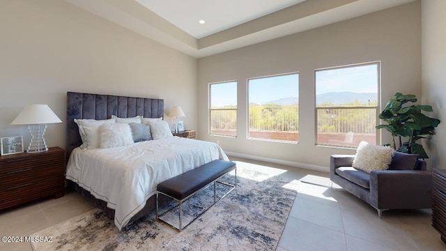 bedroom featuring a mountain view and light tile patterned floors