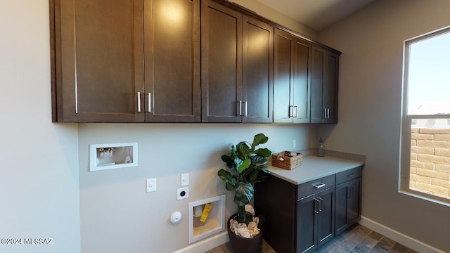 clothes washing area featuring gas dryer hookup, hookup for a washing machine, cabinets, and hookup for an electric dryer