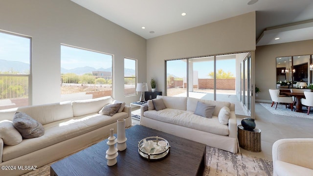 living room featuring a mountain view, high vaulted ceiling, and plenty of natural light