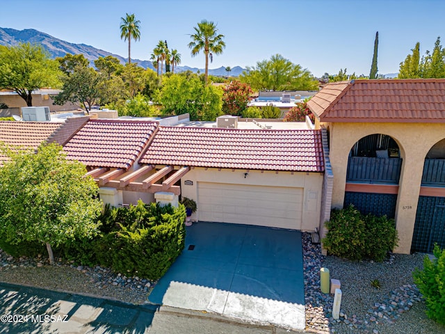 view of front facade featuring a mountain view and a garage