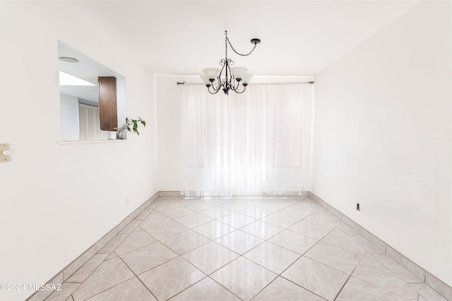 empty room with a notable chandelier