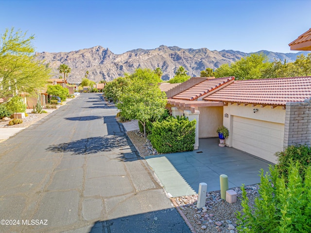 view of front facade featuring a mountain view and a garage