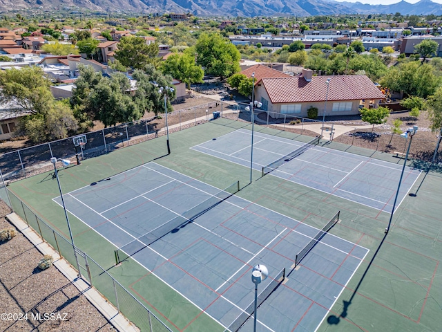 view of tennis court with a mountain view