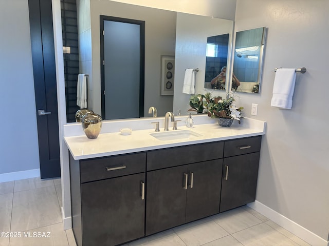 bathroom featuring vanity, tile patterned flooring, and baseboards