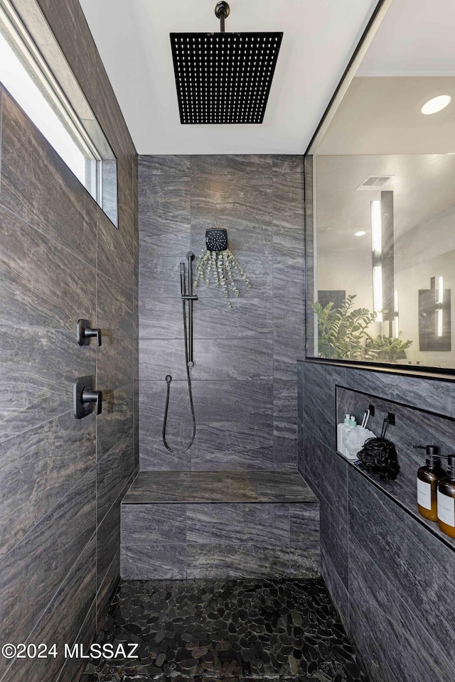 bathroom featuring a tile shower