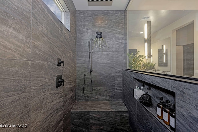 bathroom featuring a tile shower