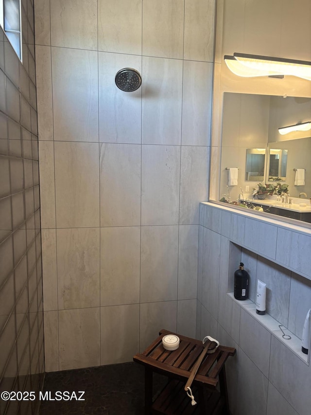 bathroom featuring tile walls and tiled shower