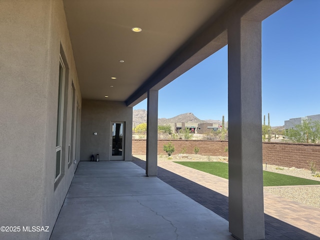 view of patio featuring a mountain view and a fenced backyard