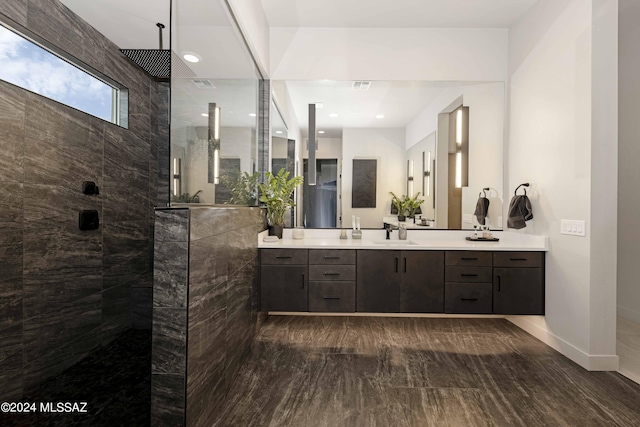 bathroom featuring vanity and a tile shower