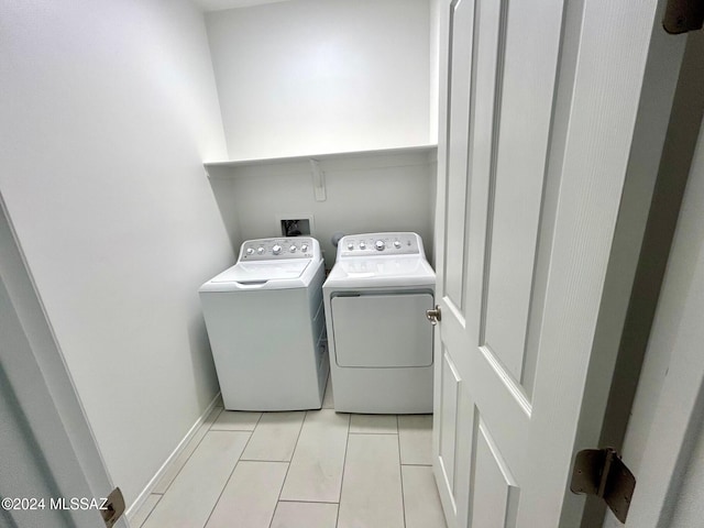 clothes washing area with washing machine and dryer