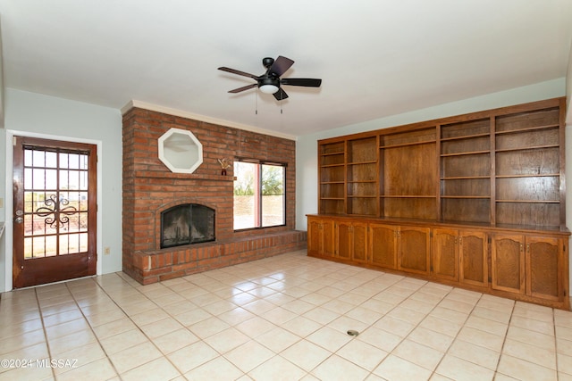 unfurnished living room with a fireplace, light tile patterned floors, and ceiling fan