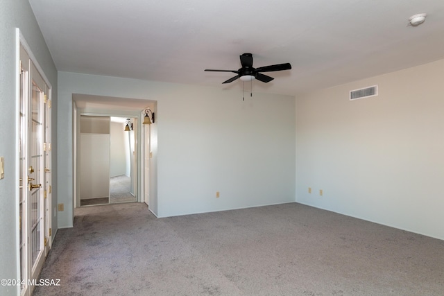 carpeted empty room featuring ceiling fan