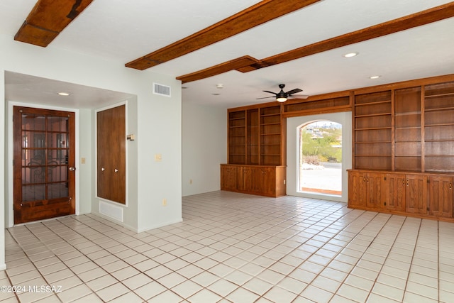 unfurnished living room with beamed ceiling, light tile patterned floors, built in features, and ceiling fan