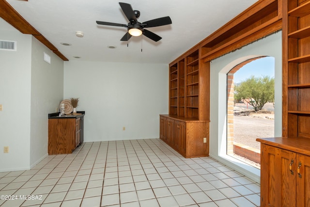 tiled empty room with ceiling fan