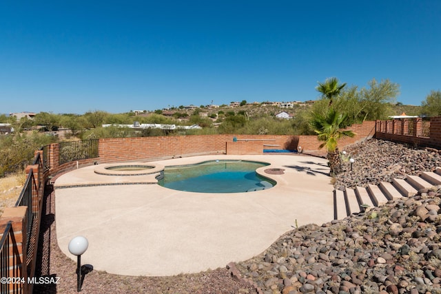 view of pool with an in ground hot tub and a patio