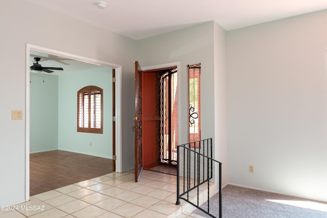 empty room with light tile patterned floors and ceiling fan