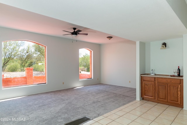 interior space with ceiling fan