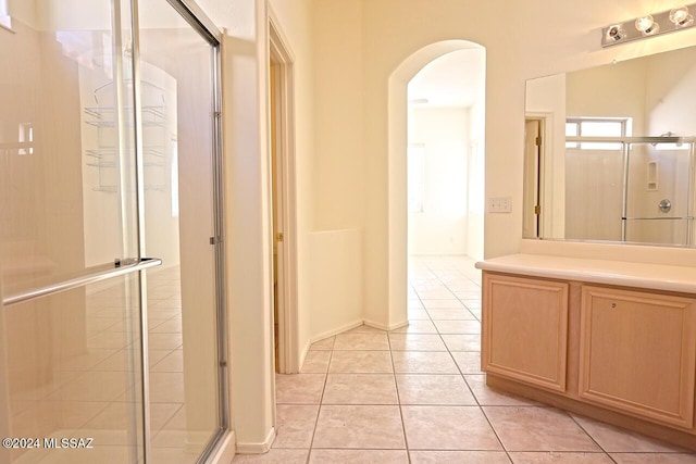 bathroom with vanity, an enclosed shower, and tile patterned flooring