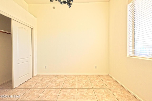 interior space with a closet and light tile patterned flooring