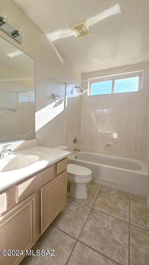 full bathroom featuring vanity, toilet, tiled shower / bath, and tile patterned floors