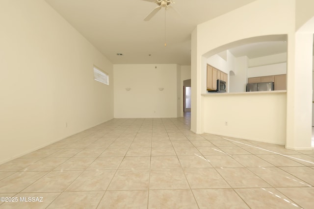 empty room featuring ceiling fan and light tile patterned floors