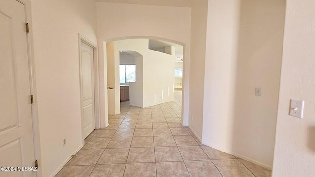 hall featuring light tile patterned floors