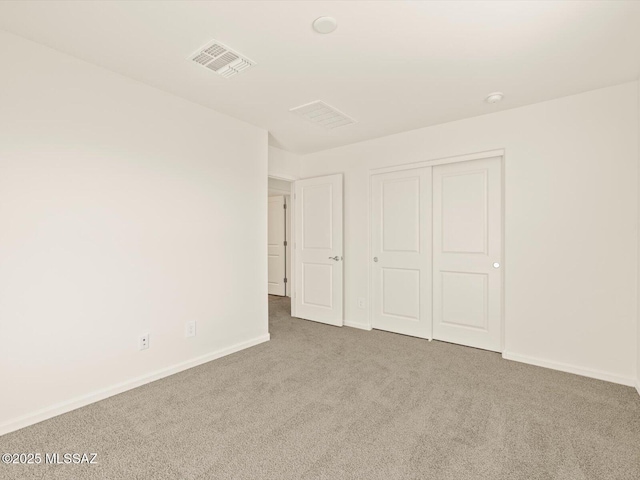 unfurnished bedroom featuring a closet and carpet