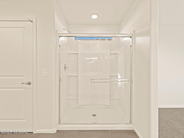 bathroom featuring a shower with door