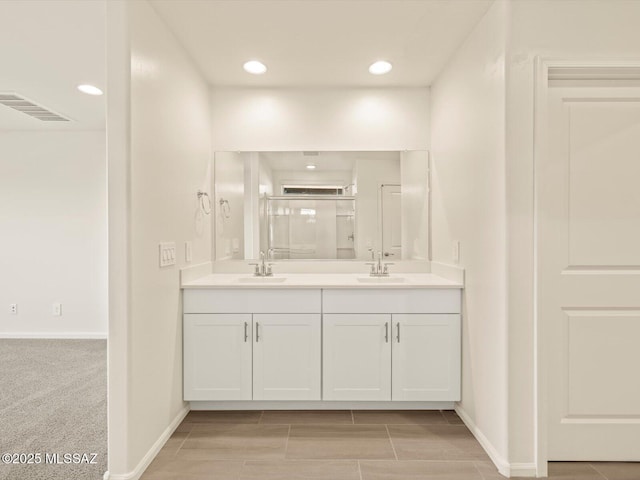 bathroom featuring vanity and a shower with shower door