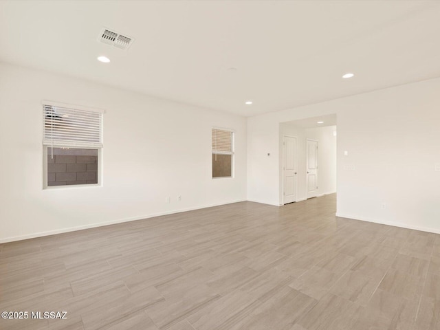 empty room with light hardwood / wood-style floors