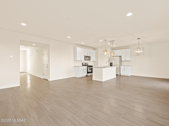 unfurnished living room with sink and a chandelier