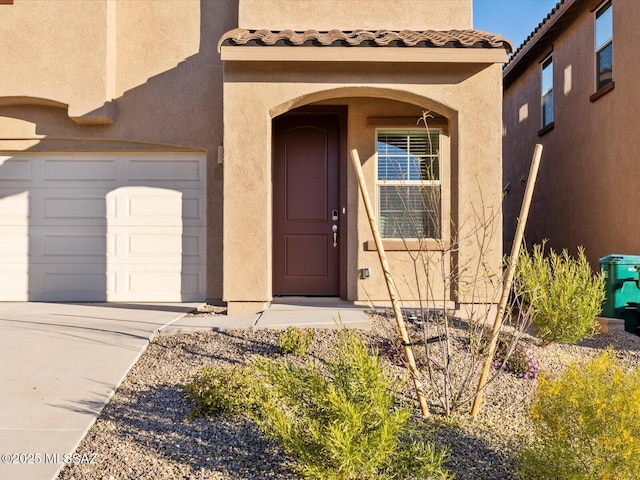 view of exterior entry featuring a garage